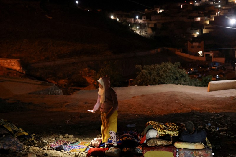 Mohammed Elhmatif and his sons, Rayan, right, and Ali, stand amidst the rubble of their home which was damaged by the earthquake, in Ijjoukak village, near Marrakech, Morocco, Saturday, Sept. 9, 2023. A rare, powerful earthquake struck Morocco, sending people racing from their beds into the streets and toppling buildings in mountainous villages and ancient cities not built to withstand such force. (AP Photo/Mosa'ab Elshamy)