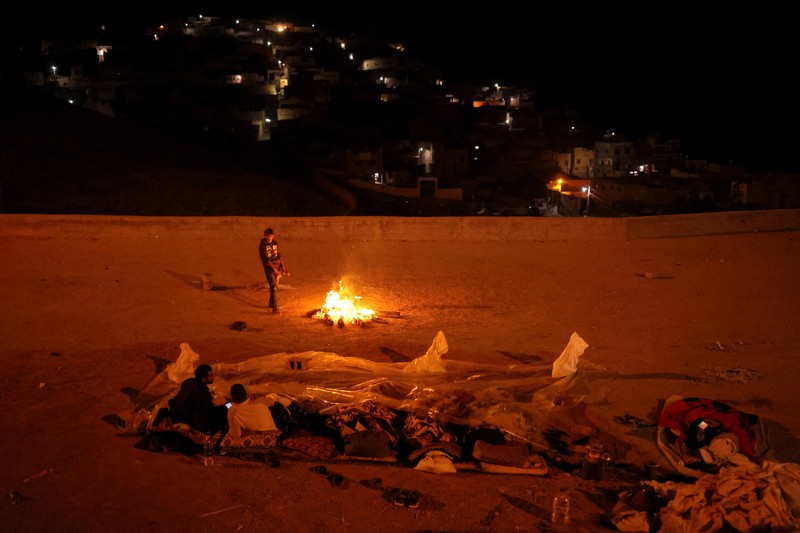 Residents sleep on the street in Moulay Brahim village, in the province of Al Haouz, following a powerful earthquake in Morocco, September 9, 2023. REUTERS/Nacho Doce