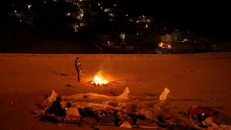 Residents sleep on the street in Moulay Brahim village, in the province of Al Haouz, following a powerful earthquake in Morocco, September 9, 2023. REUTERS/Nacho Doce