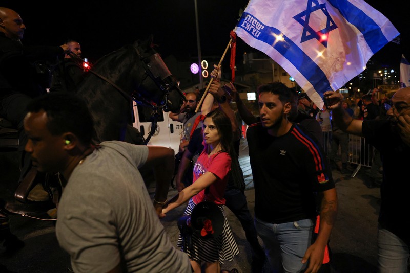 Orang-orang mengambil bagian dalam demonstrasi menentang Perdana Menteri Israel Benjamin Netanyahu dan perombakan peradilan pemerintahan koalisi nasionalisnya menjelang banding terhadap amandemen yang membatasi beberapa kekuasaan Mahkamah Agung, di Yerusalem, 11 September 2023. Orang-orang mengambil bagian dalam demonstrasi menentang Perdana Menteri Israel Benjamin Netanyahu dan perombakan peradilan pemerintahan koalisi nasionalisnya menjelang banding terhadap amandemen yang membatasi beberapa kekuasaan Mahkamah Agung, di Yerusalem, 11 September 2023. (REUTERS/Ronen Zvulun)