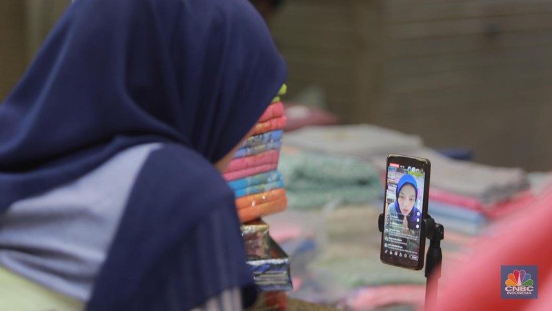Pedagang menawarkan produk daganganya secara daring melalui siaran langsung di Pasar Tanah Abang, Blok B, Jakarta, Rabu (13/9/2023). (CNBC Indonesia/Muhammad Sabki)