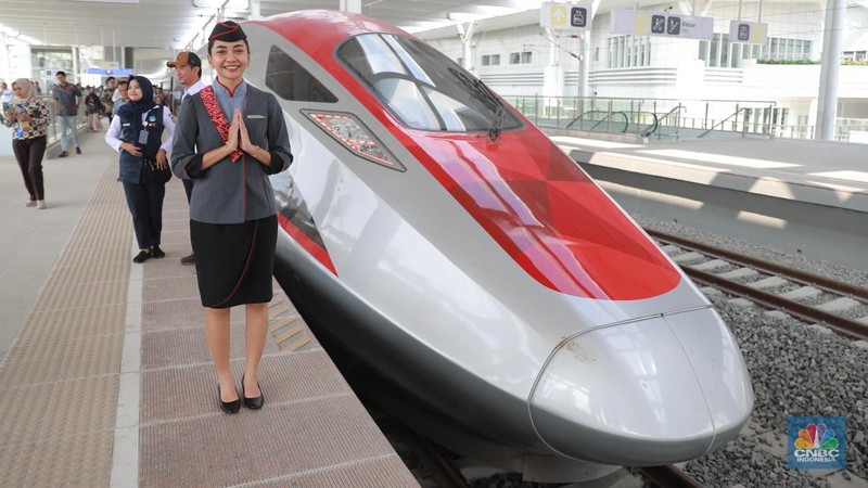 Petugas Passenger Service Kereta Api Cepat Jakarta Bandung berpose di samping kereta cepat, di Stasiun Halim, Jakarta, Jumat, (15/9). (CNBC Indonesia/Muhammad Sabki)