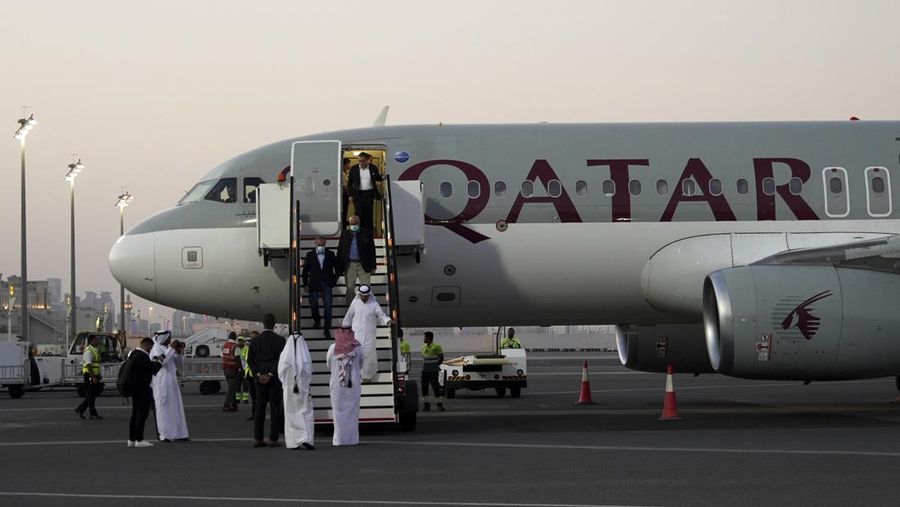 Emad Sharghi, Morad Tahbaz and Siamak Namazi, former prisoners in Iran, walk out of a Qatar Airways flight that brought them out of Tehran and to Doha, Qatar, Monday, Sept. 18, 2023. Five prisoners sought by the U.S. in a swap with Iran were freed Monday and headed home as part of a deal that saw nearly $6 billion in Iranian assets unfrozen. (AP Photo/Lujain Jo)