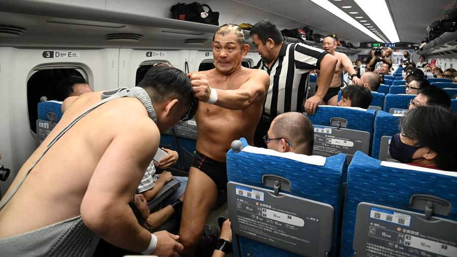 Minoru Suzuki and Sanshiro Takagi, wrestlers from Japanese professional wrestling promotion DDT Pro-Wrestling, fight inside Tokaido Shinkansen bullet train from Tokyo to Nagoya during a wrestling show in Japan September 18, 2023, in this handout photo released by JR Tokai (The Central Japan Railway Company).  JR Tokai/Handout via REUTERS  ATTENTION EDITORS - THIS IMAGE HAS BEEN SUPPLIED BY A THIRD PARTY. MANDATORY CREDIT. NO RESALES. NO ARCHIVES.