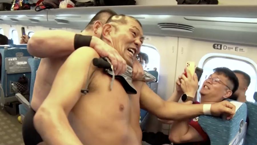 Minoru Suzuki and Sanshiro Takagi, wrestlers from Japanese professional wrestling promotion DDT Pro-Wrestling, fight inside Tokaido Shinkansen bullet train from Tokyo to Nagoya during a wrestling show in Japan September 18, 2023, in this handout photo released by JR Tokai (The Central Japan Railway Company).  JR Tokai/Handout via REUTERS  ATTENTION EDITORS - THIS IMAGE HAS BEEN SUPPLIED BY A THIRD PARTY. MANDATORY CREDIT. NO RESALES. NO ARCHIVES.