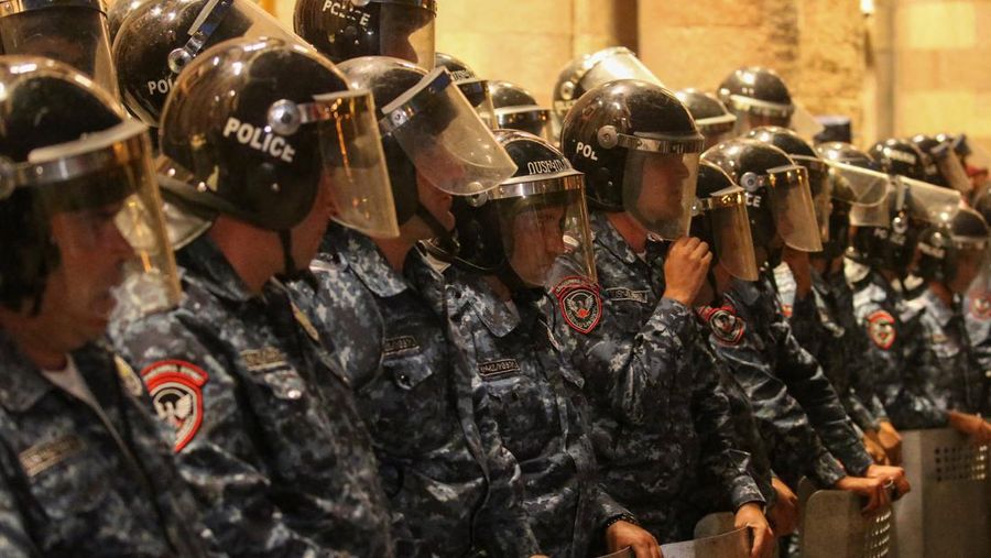 Protesters sit in front of law enforcement officers near the government building during a rally to support ethnic Armenians in Nagorno-Karabakh following Azerbaijani armed forces' offensive operation executed in the region, in Yerevan, Armenia, September 20, 2023. REUTERS/Irakli Gedenidze