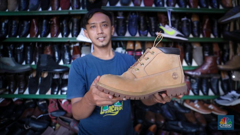 Pedagang sepatu menunggu pembeli di pasar Taman Puring, Kebayoran, Jakarta, Senin (25/9/2023). Pasar Taman Puring yang pada awal tahun 2.000-an menjadi primadona anak muda Jakarta membeli sepatu brand ternama, kini sepi akibat masifnya penjualan online melalaui platform media sosial. (CNBC Indonesia/Faisal Rahman)