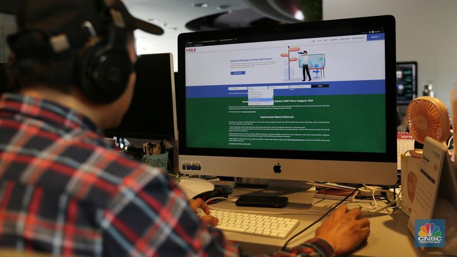 Seorang pria mencoba untuk masuk ke situs SSCASN 2023. (CNBC Indonesia/Tias Budiarto)
