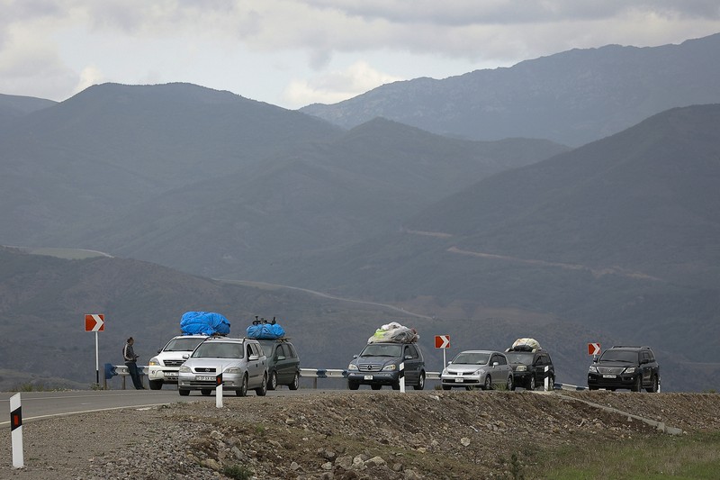 A convoy of cars of ethnic Armenians from Nagorno-Karabakh move to Kornidzor in Syunik region, Armenia, Tuesday, Sept. 26, 2023. Thousands of Armenians have streamed out of Nagorno-Karabakh after the Azerbaijani military reclaimed full control of the breakaway region last week. (AP Photo/Vasily Krestyaninov)
