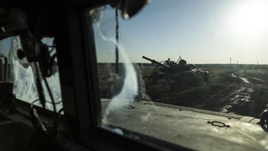 A destroyed tank is seen from the window of an armoured vehicle at the frontline near Klishchiivka, Donetsk region, Ukraine, Sunday, Sept. 24, 2023. (AP Photo/Alex Babenko).
