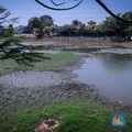 Seorang warga berjalan di tanah yang retak akibat kekeringan di Danau Cinere, Depok, Jawa Barat, Rabu (27/9/2023). (CNBC Indonesia/Faisal Rahman)