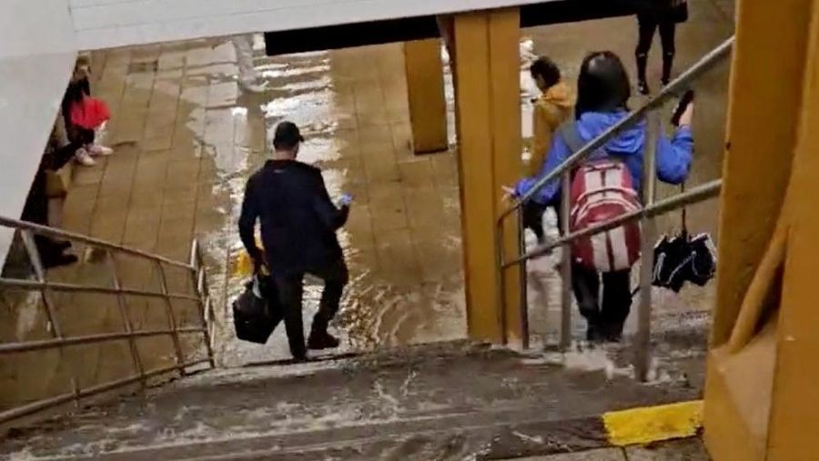 People walk in a flooded Grand Army Plaza subway station following Tropical Storm Ophelia, in New York, U.S., September 29, 2023 in this still image from video obtained from social media. @ANDREF1989 VIA X/via REUTERS THIS IMAGE HAS BEEN SUPPLIED BY A THIRD PARTY. MANDATORY CREDIT. NO RESALES. NO ARCHIVES.