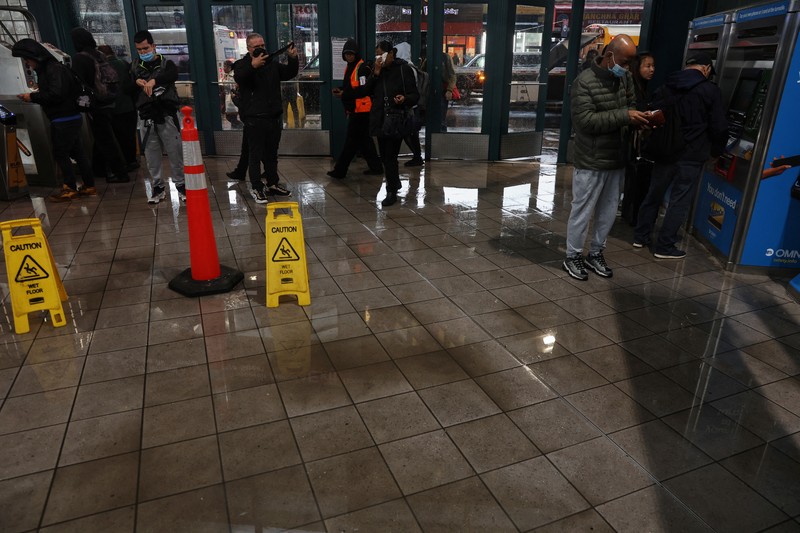 A police officer from the NYPD Highway Patrol looks to motorists drive through a flooded street after heavy rains as the remnants of Tropical Storm Ophelia bring flooding across the mid-Atlantic and Northeast, at the FDR Drive in Manhattan near the Williamsburg Bridge, in New York City, U.S., September 29, 2023.  REUTERS/Andrew Kelly     TPX IMAGES OF THE DAY