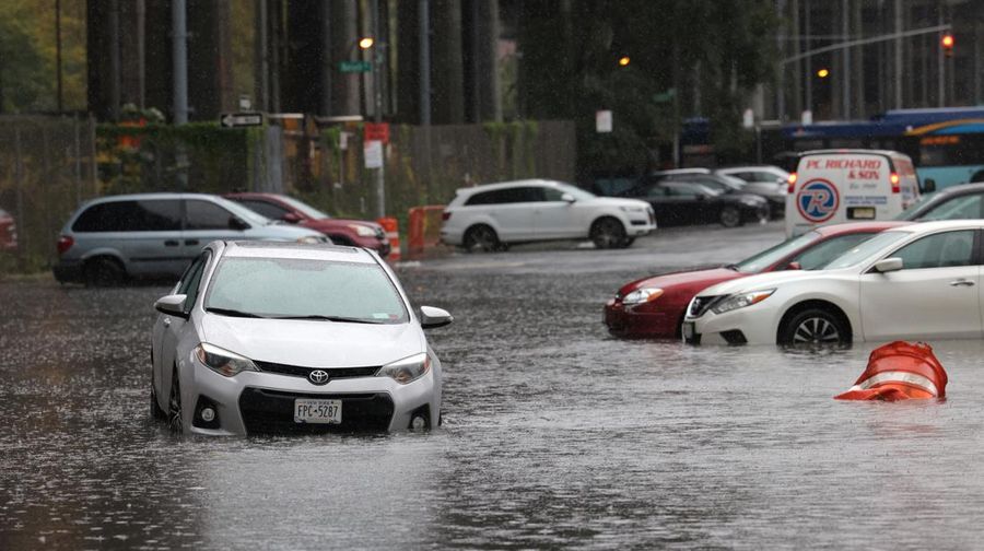 A police officer from the NYPD Highway Patrol looks to motorists drive through a flooded street after heavy rains as the remnants of Tropical Storm Ophelia bring flooding across the mid-Atlantic and Northeast, at the FDR Drive in Manhattan near the Williamsburg Bridge, in New York City, U.S., September 29, 2023.  REUTERS/Andrew Kelly     TPX IMAGES OF THE DAY