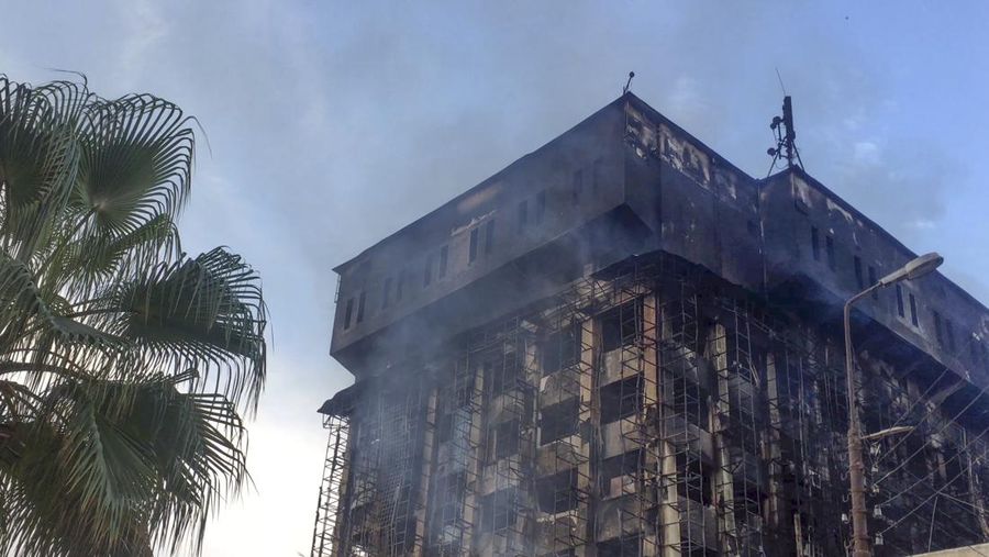 Kepulan asap terlihat dari markas polisi yang terbakar di Ismailia, Timur Laut Mesir. Senin (2/10/2023). (AP Photo/Mohammed Awad)