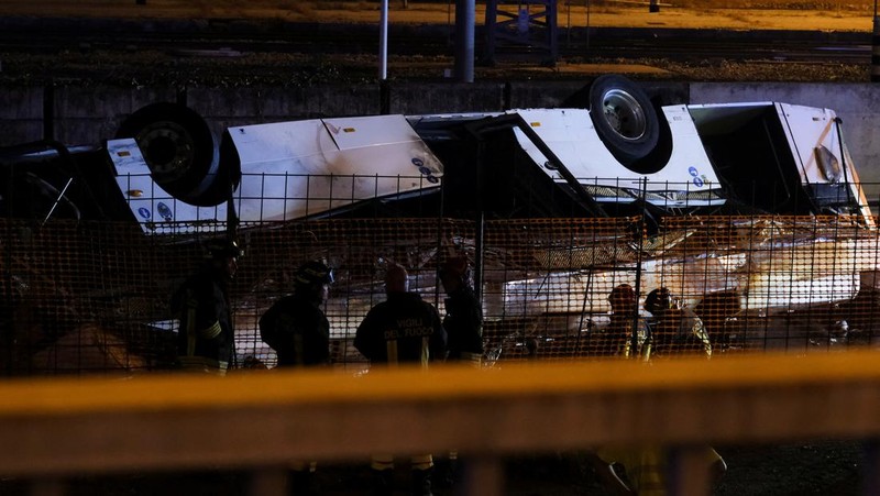 Petugas penyelamat hadir di lokasi kejadian, setelah sebuah bus jatuh dari jembatan layang di Mestre, Italia, 3 Oktober 2023. (REUTERS/Manuel Silvestri)