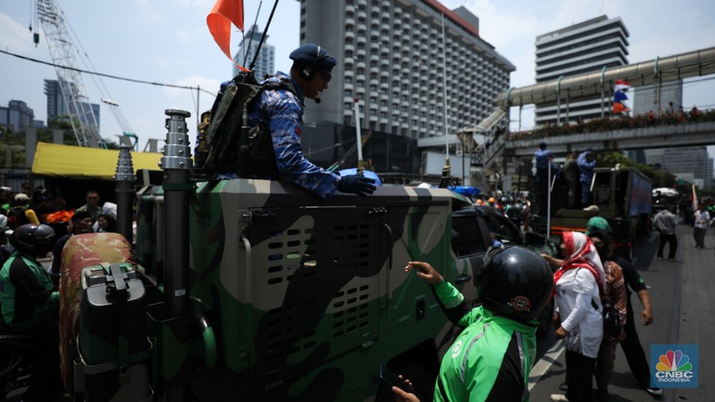 Warga menyaksikan parade militer HUT TNI ke 78 di Jakarta, Kamis (5/10/2023). (CNBC Indonesia/Tri Susilo)