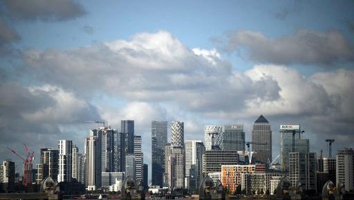 The towers and office buildings of the Canary Wharf financial and business district pictured beyond the Thames Barrier and the River Thames, from Woolwich, in south London on September 29, 2023. Britain's economy grew more than expected in the first quarter, revised official data showed Friday, but remains at risk of recession as high inflation weighs on the country. (Photo by Daniel LEAL / AFP)