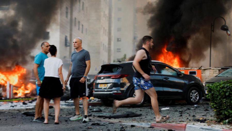 Orang-orang bereaksi di jalan, pasca serangan roket yang diluncurkan dari Gaza, di Ashkelon, Israel 7 Oktober 2023. (REUTERS/Amir Cohen)