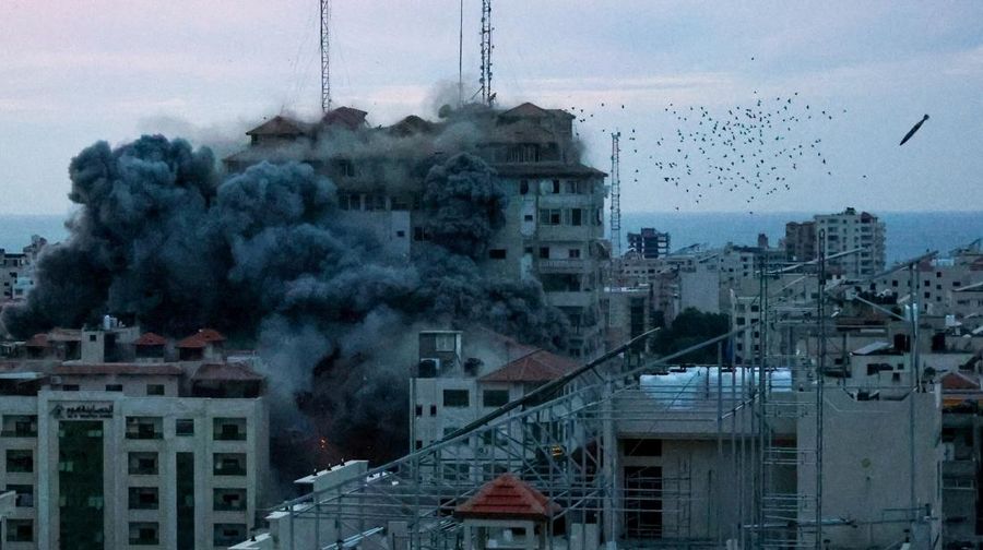 A missile lands as smoke billows while Israeli forces strike a high-rise tower in Gaza City, October 7, 2023. REUTERS/Ahmed Zakot