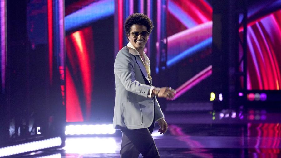 Bruno Mars of Silk Sonic walks on stage to accept the award for best duo/group of the year at the iHeartRadio Music Awards on Tuesday, March 22, 2022, at the Shrine Auditorium in Los Angeles. (AP Photo/Chris Pizzello)