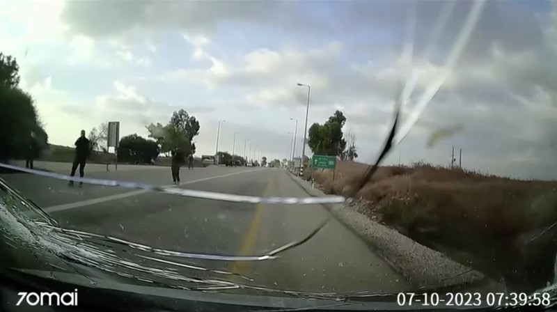 CCTV footage shows a Hamas Islamist militant firing upon a car during an ambush while the occupants were waiting to enter the Be'eri kibbutz through a gate, in southern Israel, October 7, 2023 in this still image from video. South First Responders via Telegram via REUTERS   THIS IMAGE HAS BEEN SUPPLIED BY A THIRD PARTY. MANDATORY CREDIT. NO RESALES. NO ARCHIVES. IMAGE BLURRED AT SOURCE