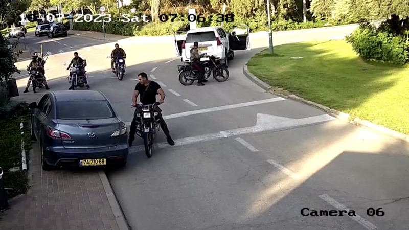 CCTV footage shows a Hamas Islamist militant firing upon a car during an ambush while the occupants were waiting to enter the Be'eri kibbutz through a gate, in southern Israel, October 7, 2023 in this still image from video. South First Responders via Telegram via REUTERS   THIS IMAGE HAS BEEN SUPPLIED BY A THIRD PARTY. MANDATORY CREDIT. NO RESALES. NO ARCHIVES. IMAGE BLURRED AT SOURCE