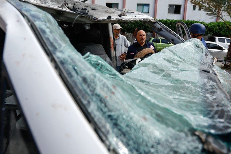 Israel Palestinians Palestinian medics inspect a damaged Ambulance hit by an Israeli air strike inside Nasser Hospital in Khan Younis, southern Gaza Strip, Saturday, Oct. 7, 2023. The militant Hamas rulers of the Gaza Strip carried out an unprecedented, multi-front attack on Israel at daybreak Saturday, firing thousands of rockets as dozens of Hamas fighters infiltrated the heavily fortified border in several locations by air, land, and sea and catching the country off-guard on a major holiday. (AP Photo/Hassan Eslaiah)