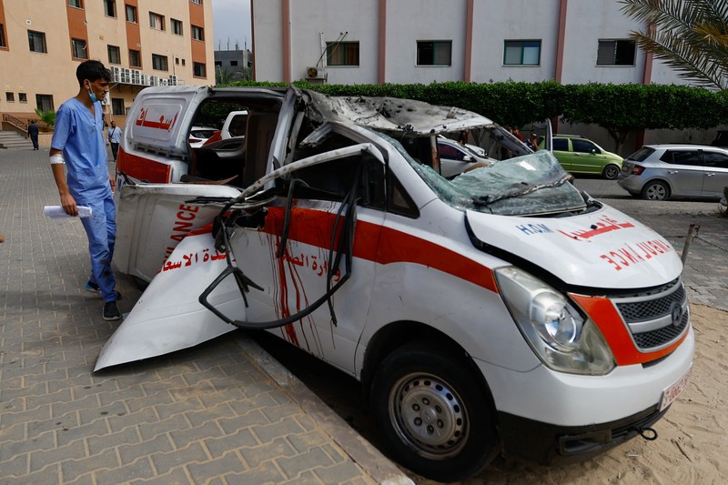 Israel Palestinians Palestinian medics inspect a damaged Ambulance hit by an Israeli air strike inside Nasser Hospital in Khan Younis, southern Gaza Strip, Saturday, Oct. 7, 2023. The militant Hamas rulers of the Gaza Strip carried out an unprecedented, multi-front attack on Israel at daybreak Saturday, firing thousands of rockets as dozens of Hamas fighters infiltrated the heavily fortified border in several locations by air, land, and sea and catching the country off-guard on a major holiday. (AP Photo/Hassan Eslaiah)