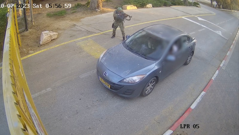 ISRAEL-PALESTINIANS/KIBBUTZ CCTV footage shows a Hamas Islamist militant firing upon a car during an ambush while the occupants were waiting to enter the Be'eri kibbutz through a gate, in southern Israel, October 7, 2023 in this still image from video. South First Responders via Telegram via REUTERS THIS IMAGE HAS BEEN SUPPLIED BY A THIRD PARTY. MANDATORY CREDIT. NO RESALES. NO ARCHIVES. IMAGE BLURRED AT SOURCE