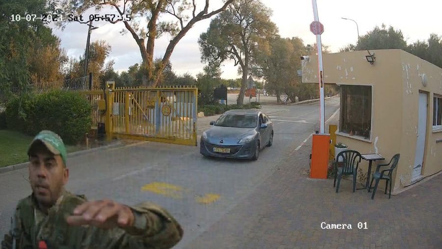 CCTV footage shows a Hamas Islamist militant firing upon a car during an ambush while the occupants were waiting to enter the Be'eri kibbutz through a gate, in southern Israel, October 7, 2023 in this still image from video. South First Responders via Telegram via REUTERS   THIS IMAGE HAS BEEN SUPPLIED BY A THIRD PARTY. MANDATORY CREDIT. NO RESALES. NO ARCHIVES. IMAGE BLURRED AT SOURCE
