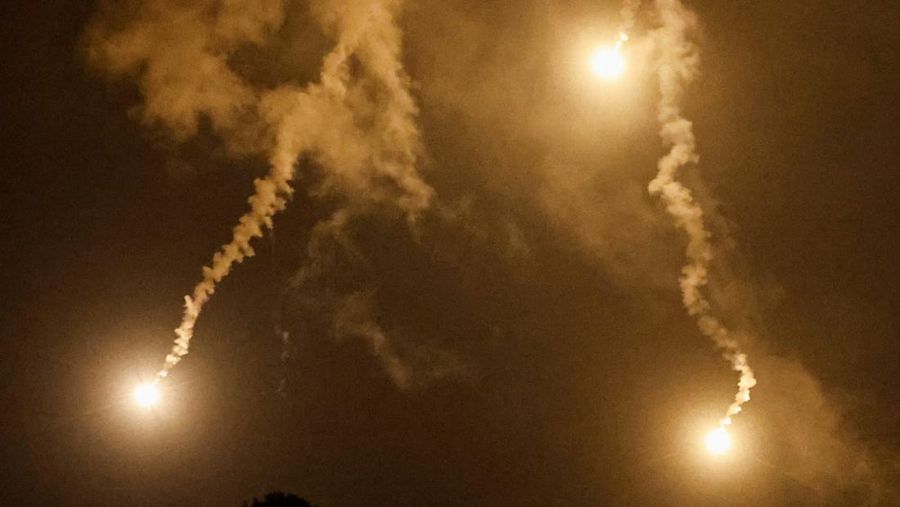 Flares, fired from the Israeli side, burn in the sky as seen from Ramyah near the Lebanese-Israeli border, in southern Lebanon, October 11, 2023. REUTERS/Thaier Al-Sudani