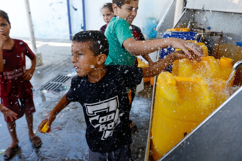 Sejumlah anak antre untuk mendapatkan air bersih di jalur Gaza. (REUTERS/Ibraheem Abu Mustafa) Sejumlah anak antre untuk mendapatkan air bersih di jalur Gaza. (REUTERS/Ibraheem Abu Mustafa)