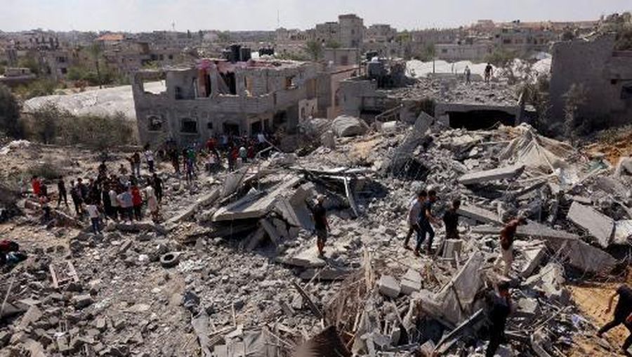 Pemandangan umum bangunan yang hancur saat tim pertahanan sipil melakukan operasi pencarian dan penyelamatan sementara serangan udara Israel berlanjut pada hari keenam di Rafah, Gaza pada 12 Oktober 2023. (Photo by SAID KHATIB / AFP)
