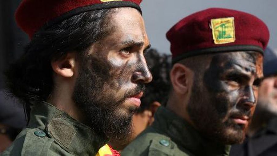 Hezbollah members attend the funeral of their comrades in the southern village of Khirbet Silem on October 10, 2023. Israeli strikes on Lebanon killed three Hezbollah members on October 9, the Iran-backed group said, as tensions surged after Palestinian militants tried to infiltrate into Israel from Lebanon. (Photo by Mahmoud ZAYYAT / AFP)