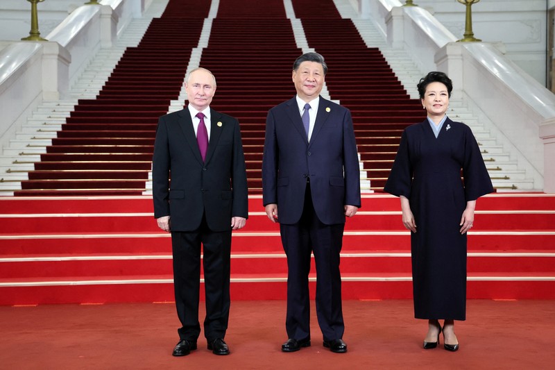 Presiden Rusia Vladimir Putin disambut oleh Presiden Tiongkok Xi Jinping dan istrinya Peng Liyuan dalam upacara di Belt and Road Forum di Beijing, Tiongkok, 17 Oktober 2023. (Sputnik/Sergei Savostyanov/Pool via REUTERS)