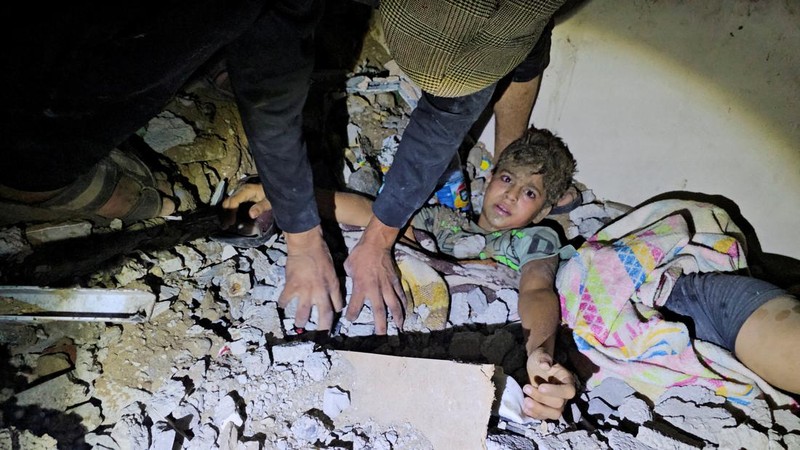 Rockets are fired from the Gaza Strip toward Israel over destroyed buildings following Israeli airstrikes on Gaza City, central Gaza Strip, Thursday, Oct. 19, 2023. (AP Photo/Mohammed Dahman)
