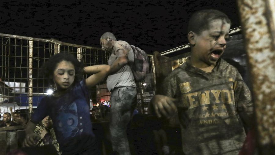 Wounded Palestinians arrive at the al-Shifa hospital, on a truck, following Israeli airstrikes on Gaza City, central Gaza Strip, Thursday, Oct. 19, 2023. (AP Photo/Abed Khaled)