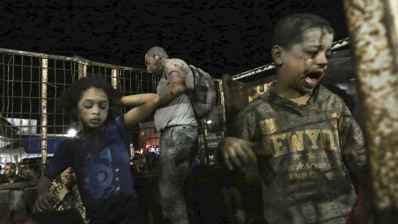 Wounded Palestinians arrive at the al-Shifa hospital, on a truck, following Israeli airstrikes on Gaza City, central Gaza Strip, Thursday, Oct. 19, 2023. (AP Photo/Abed Khaled)