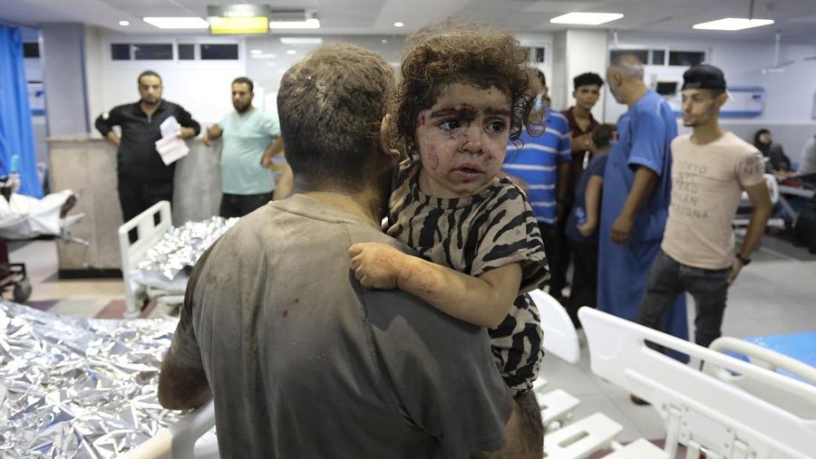 Wounded Palestinians arrive at the al-Shifa hospital, following Israeli airstrikes on Gaza City, central Gaza Strip, Thursday, Oct. 19, 2023. (AP Photo/Abed Khaled)