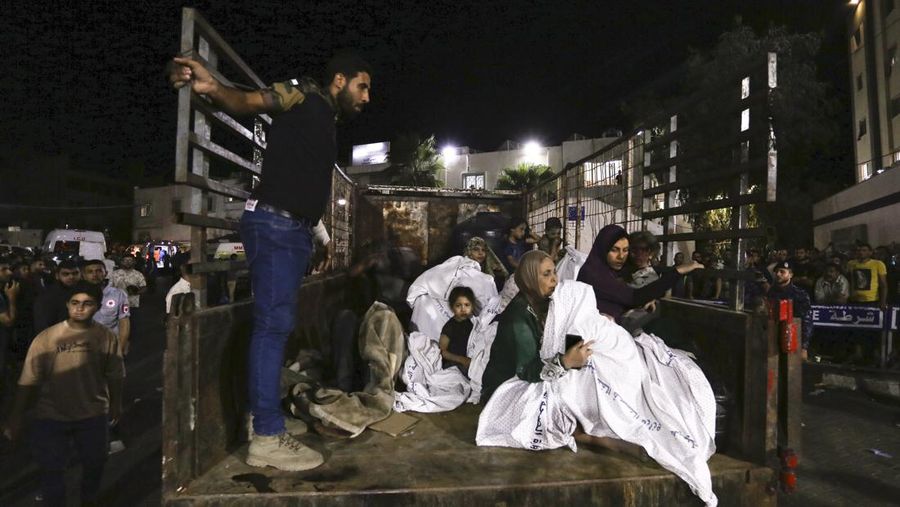Wounded Palestinians arrive at the al-Shifa hospital, on a truck, following Israeli airstrikes on Gaza City, central Gaza Strip, Thursday, Oct. 19, 2023. (AP Photo/Abed Khaled)