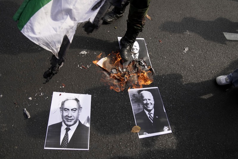 Seorang pengunjuk rasa memperlihatkan poster Perdana Menteri Israel Benjamin Netanyahu yang dirusak selama unjuk rasa mendukung rakyat Palestina di luar Kementerian Luar Negeri Indonesia di Jakarta, Indonesia, Jumat, 20 Oktober 2023. Seorang pengunjuk rasa memperlihatkan poster Perdana Menteri Israel Benjamin Netanyahu yang dirusak selama unjuk rasa mendukung rakyat Palestina di luar Kementerian Luar Negeri Indonesia di Jakarta, Indonesia, Jumat, 20 Oktober 2023. Ratusan orang melancarkan protes di ibu kota Indonesia pada hari Jumat untuk mengecam kelompok tersebut. Dukungan Amerika terhadap Israel dan menuntut diakhirinya serangan udara Israel di Jalur Gaza. (AP Photo/Dita Alangkara)