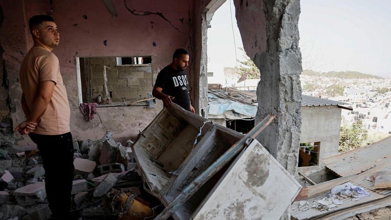 Warga Palestina memeriksa sisa-sisa masjid yang hancur akibat serangan Israel, saat konflik antara Israel dan kelompok Islam Palestina Hamas berlanjut, di Jalur Gaza utara 22 Oktober 2023. (REUTERS/Anas al-Shareef)