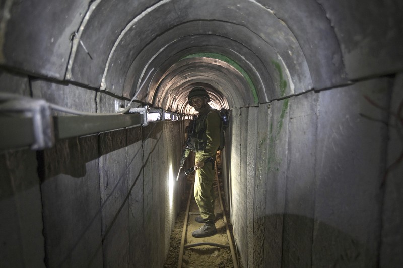 Israel Palestinians Hamas Tunnels FILE - A Palestinian youth walks inside a tunnel used for military exercises during a weapon exhibition at a Hamas-run youth summer camp in Gaza City July 20, 2016. An extensive labyrinth of tunnels built by Hamas stretches across the dense neighborhoods of the Gaza Strip, hiding militants, their missile arsenal and the over 200 hostages they now hold after an unprecedented Oct. 7, 2023, attack on Israel. (AP Photo/Adel Hana, File)