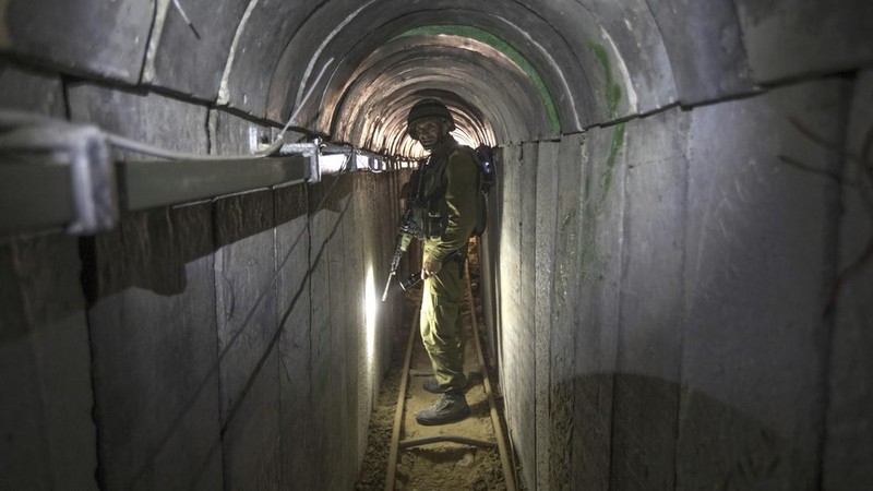 FILE - A Palestinian youth walks inside a tunnel used for military exercises during a weapon exhibition at a Hamas-run youth summer camp in Gaza City July 20, 2016. An extensive labyrinth of tunnels built by Hamas stretches across the dense neighborhoods of the Gaza Strip, hiding militants, their missile arsenal and the over 200 hostages they now hold after an unprecedented Oct. 7, 2023, attack on Israel. (AP Photo/Adel Hana, File)