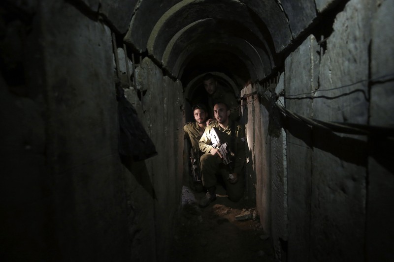 Israel Palestinians Hamas Tunnels FILE - A Palestinian youth walks inside a tunnel used for military exercises during a weapon exhibition at a Hamas-run youth summer camp in Gaza City July 20, 2016. An extensive labyrinth of tunnels built by Hamas stretches across the dense neighborhoods of the Gaza Strip, hiding militants, their missile arsenal and the over 200 hostages they now hold after an unprecedented Oct. 7, 2023, attack on Israel. (AP Photo/Adel Hana, File)