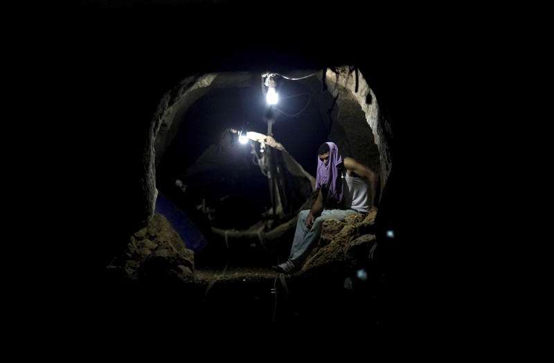 Israel Palestinians Hamas Tunnels FILE - A Palestinian youth walks inside a tunnel used for military exercises during a weapon exhibition at a Hamas-run youth summer camp in Gaza City July 20, 2016. An extensive labyrinth of tunnels built by Hamas stretches across the dense neighborhoods of the Gaza Strip, hiding militants, their missile arsenal and the over 200 hostages they now hold after an unprecedented Oct. 7, 2023, attack on Israel. (AP Photo/Adel Hana, File)