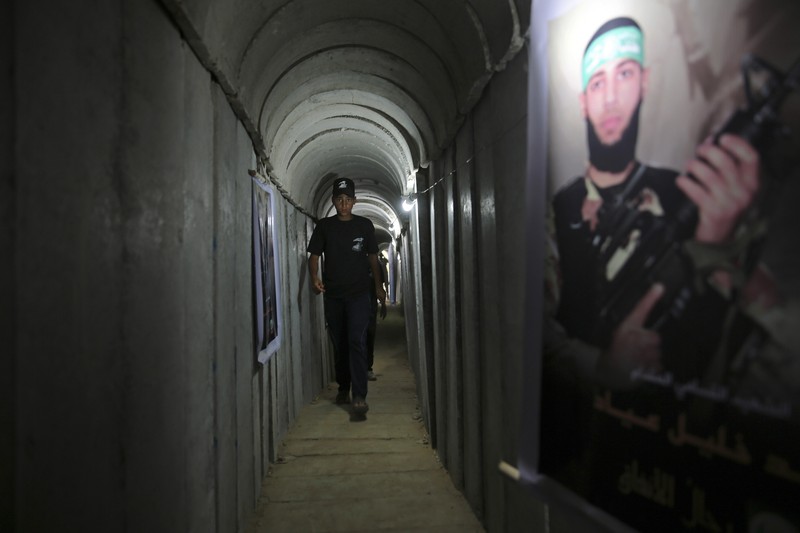 Israel Palestinians Hamas Tunnels FILE - A Palestinian youth walks inside a tunnel used for military exercises during a weapon exhibition at a Hamas-run youth summer camp in Gaza City July 20, 2016. An extensive labyrinth of tunnels built by Hamas stretches across the dense neighborhoods of the Gaza Strip, hiding militants, their missile arsenal and the over 200 hostages they now hold after an unprecedented Oct. 7, 2023, attack on Israel. (AP Photo/Adel Hana, File)