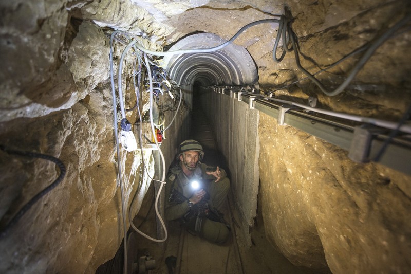 Israel Palestinians Hamas Tunnels FILE - A Palestinian youth walks inside a tunnel used for military exercises during a weapon exhibition at a Hamas-run youth summer camp in Gaza City July 20, 2016. An extensive labyrinth of tunnels built by Hamas stretches across the dense neighborhoods of the Gaza Strip, hiding militants, their missile arsenal and the over 200 hostages they now hold after an unprecedented Oct. 7, 2023, attack on Israel. (AP Photo/Adel Hana, File)
