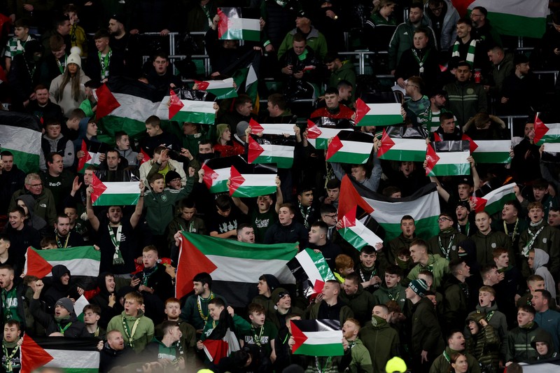 SOCCER-CHAMPIONS-CEL-ATM/REPORT Soccer Football - Champions League - Group E - Celtic v Atletico Madrid - Celtic Park, Glasgow, Scotland, Britain - October 25, 2023 Celtic fans display Palestinian flags in support of Palestine amid the ongoing conflict between Israel and the Palestinian Islamist group Hamas before the match Action Images via Reuters/Jason Cairnduff